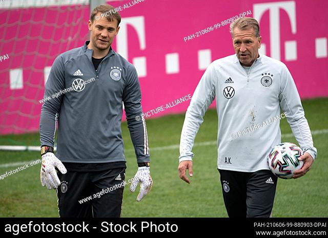 06 June 2021, Austria, Seefeld: Football: National team, training camp. Germany's goalkeeper Manuel Neuer (l) wears goalkeeper gloves he got for his 100th...