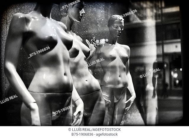 naked female mannequins in a shop window
