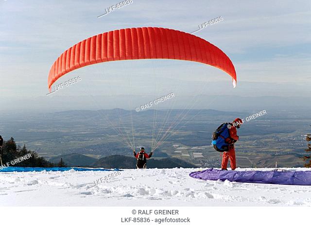 Paraglider on Kandel Mountain in Wintertime, near Waldkirch, Black Forest, Baden-Wuerttemberg, Germany