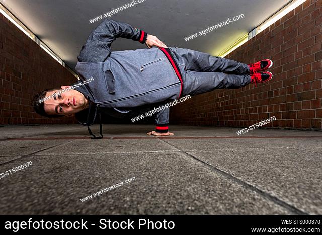 Germany, portrait of young break dancer in underpass