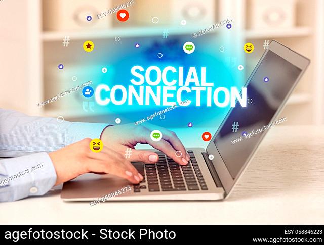 Freelance woman using laptop with SOCIAL CONNECTION inscription, Social media concept