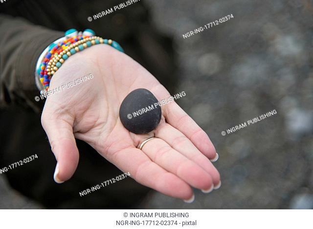 Person showing stone on the palm, Deception Pass State Park, Oak Harbor, Washington State, USA
