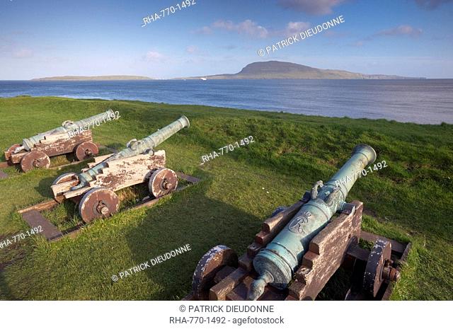 Skansin fort, old fort guarding Torshavn and its harbour, with old brass cannons, Second World War British marine guns and lighthouse, Nolsoy in the distance