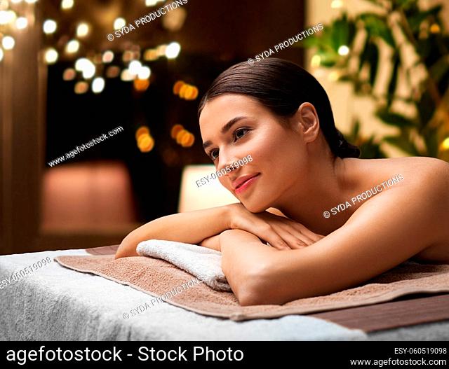 young woman lying at spa or massage parlor