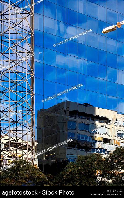 Buildings reflected in the glasses of the facade of a modern building