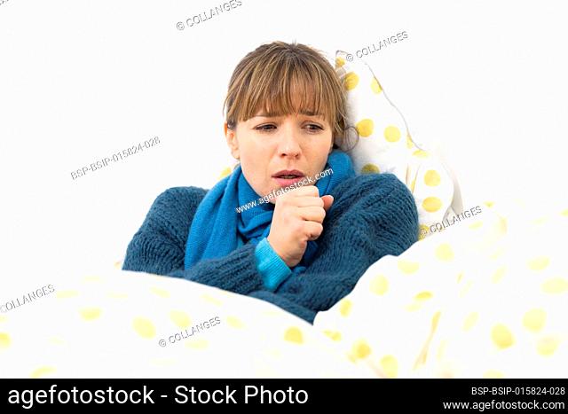 A young woman in bed suffering from a flu-like condition