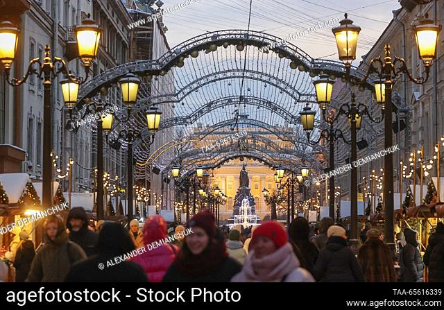 RUSSIA, ST PETERSBURG - DECEMBER 10, 2023: Citizens stroll along the rows of Christmas stalls, with the Alexandrinsky Theatre in the background