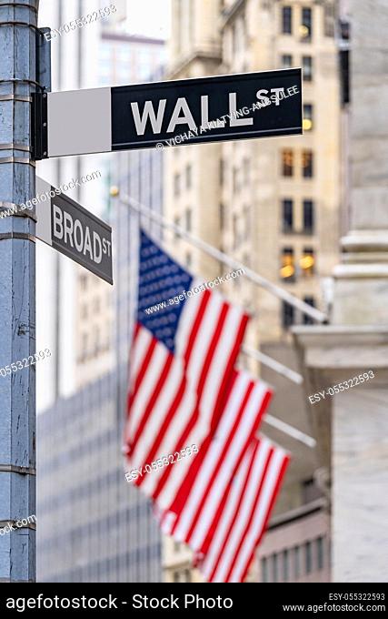 Wall street sign with New York Stock Exchange background New York City, New York, USA