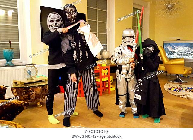 children preparing for a halloween party in a living room, Germany