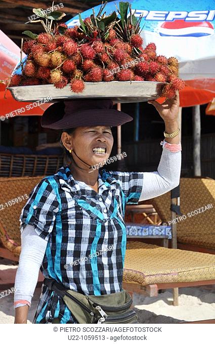 Sihanoukville (Cambodia): rambutan seller at Occheuteal Beach