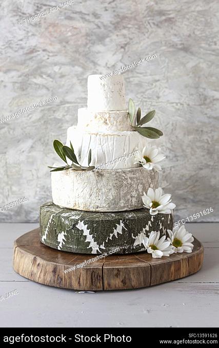 Cheese Wedding Cake - wheels of cheese arranged as a multi-tiered wedding cake, with flowers