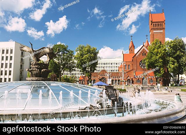 Church Of Saints Simon And Helen or Red Church And Fountain At Independence Square In Minsk, Belarus