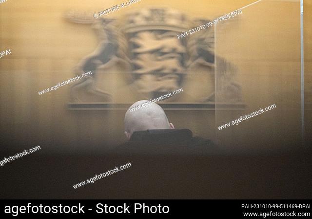10 October 2023, Baden-Württemberg, Stuttgart: A defendant sits in a room of the Stuttgart Higher Regional Court. Eleven defendants are to stand trial before...