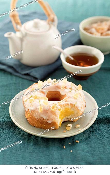 Doughnut with candied ginger pieces and sugar glaze