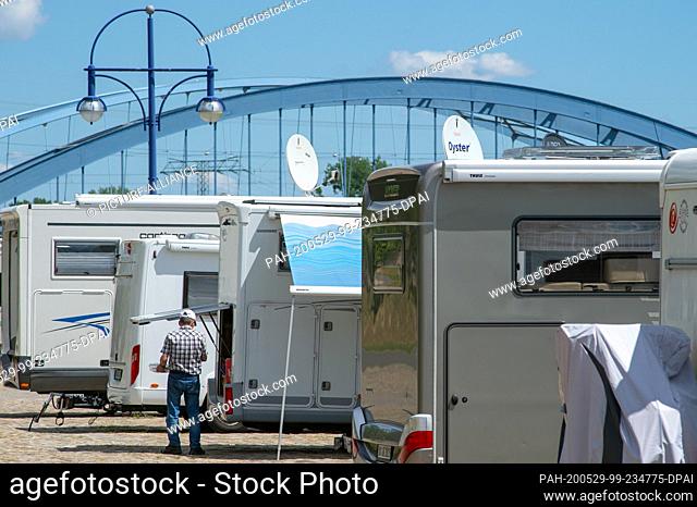 29 May 2020, Saxony-Anhalt, Magdeburg: Motorhomes stand side by side at the Petriförder on the Elbe. Since 28 May 2020, tourists from other federal states have...