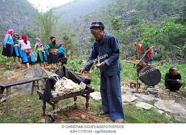 Shaman doing rituals above altar in memory of deceased, funeral in a village around Sa Phin, Ha Giang province, Northern Vietnam, southeast asia
