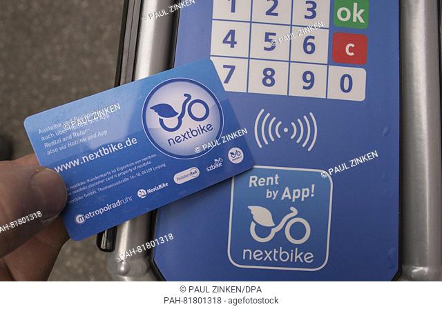 A man holding a client card onto a rentable bike of 'nextbike' in Berlin, Germany, 5 July 2016. The company 'nextbike' from Leipzig is the new provider of...
