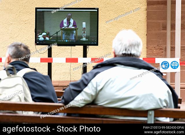 13 May 2021, Thuringia, Wachstedt: Believers sit in front of the pilgrimage church Klüschen Hagis during the alternative men's pilgrimage under the motto ""Come...