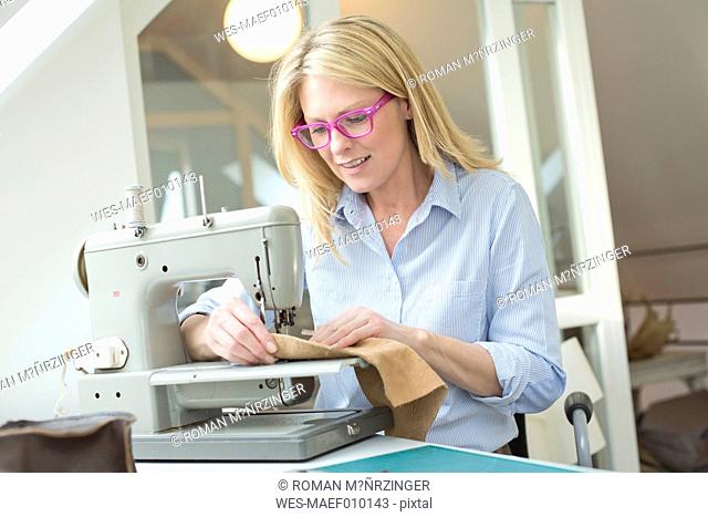 Smiling woman working on sewing machine
