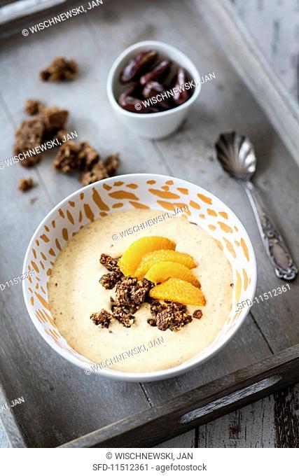A smoothie bowl with dates, gingerbread and mandarines