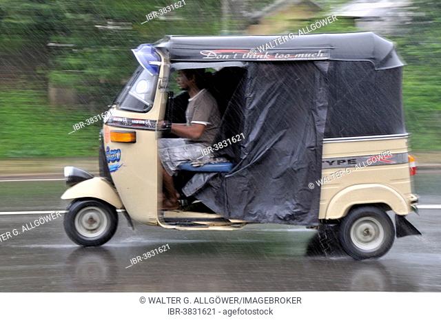 Three-wheeler in heavy rain, Sri Lanka