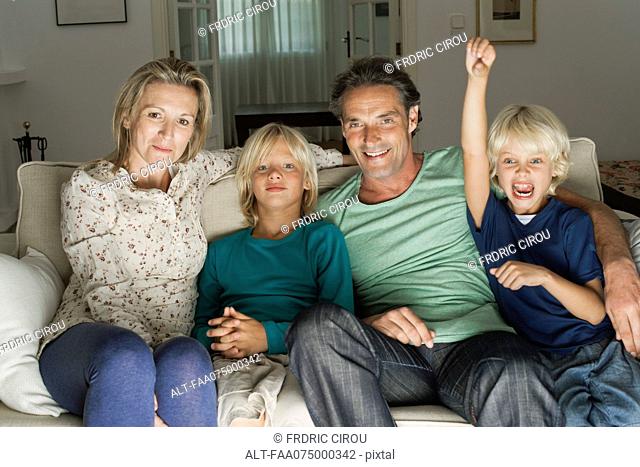 Family sitting on sofa, portrait