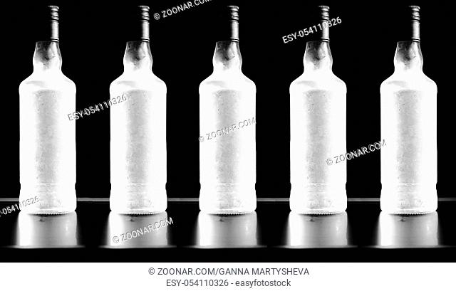 Luxury frozen vodka bottle on a black background