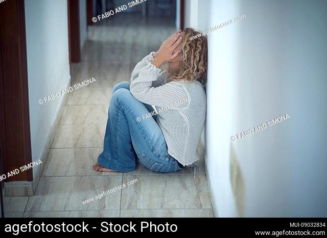 Lonley scared sad girl at home desperating and crying alone protecting face with the hands - stop violence in married life and protect female international day