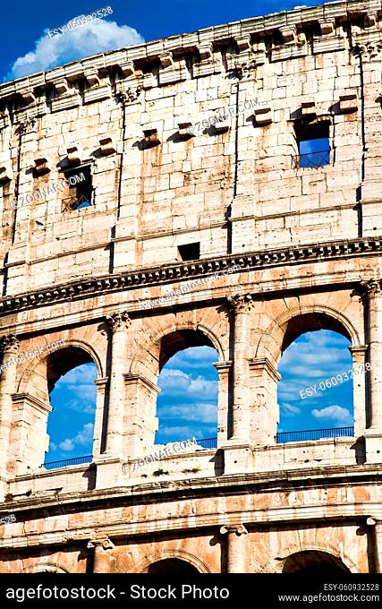 Rome, Italy. Arches archictecture of Colosseum (Colosseo) exterior with blue sky background and clouds