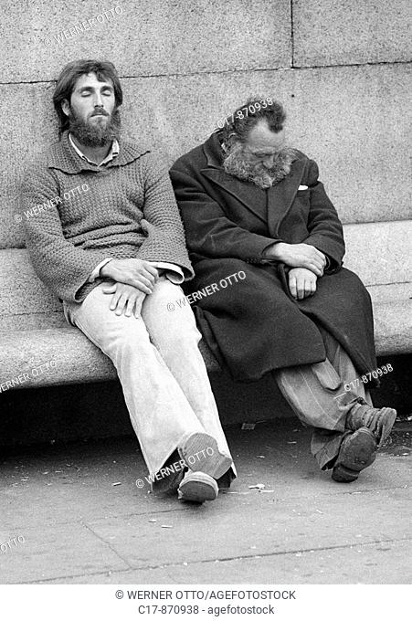 Seventies, black and white photo, people, two homeless men side by side on a bench, sleeping, depressed, aged 25 to 35 years, aged 50 to 60 years, Great Britain