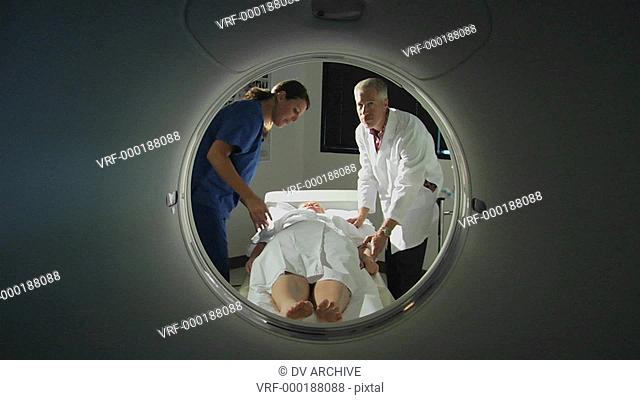 medical professionals provide reassuring words to a patient before her procedure