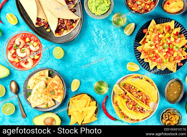 Mexican food, many dishes of the cuisine of Mexico, flat lay, shot from the top on a vibrant blue background, forming a frame with a place for text