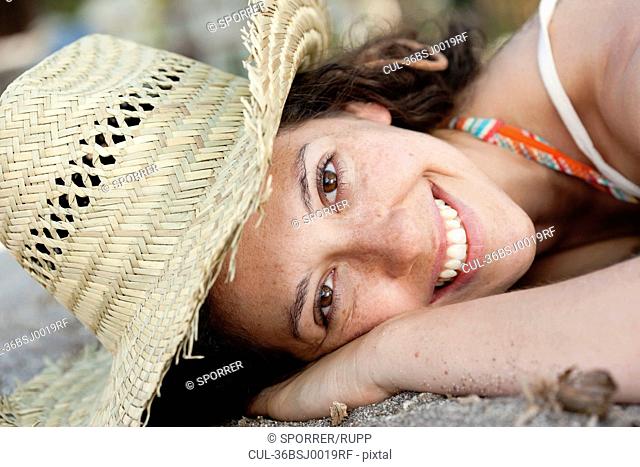 Close up of smiling woman wearing sunhat