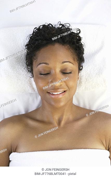 African woman laying on spa table