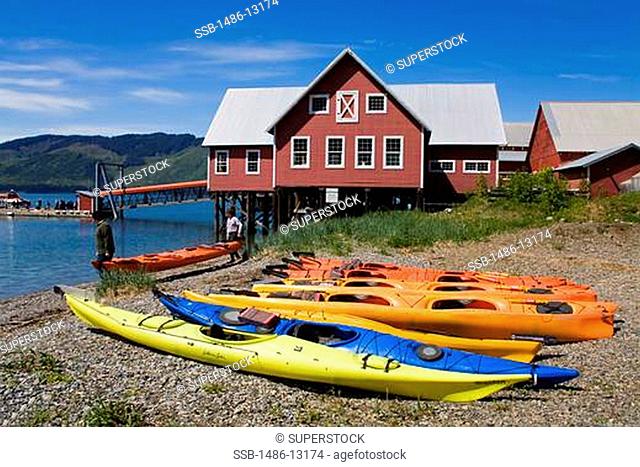 Kayaks on the coast with a museum in the background, Glacier Bay, Cannery Museum, Icy Strait Point, Hoonah City, Chichagof Island, Alaska, USA