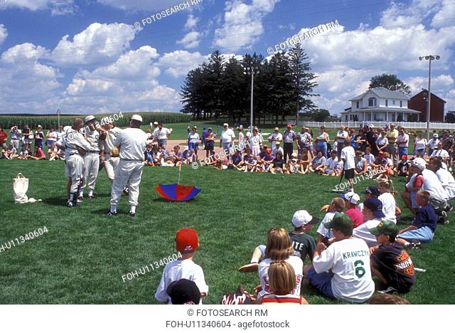 Iowa, Dyersville, Field of Dreams Movie Site in Dyersville. Crowd of people watch The Ghost Team play an exhibition baseball game with children