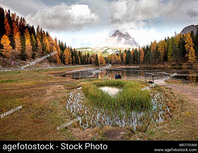 The lake of Lago di antorno with Tre cime di lavadero mountain reflection in autumn. Forest landscape South tyrol Italy