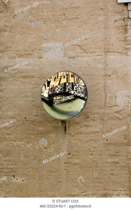 Wall mounted convex mirror with reflection of bridge