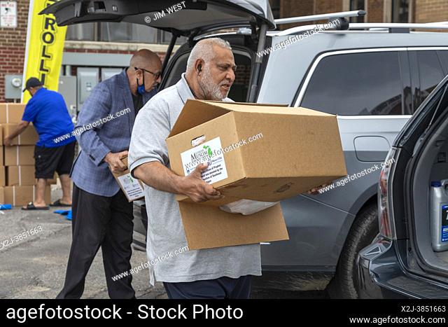 Detroit, Michigan - Members of the Michigan Muslim Community Council unload packages of lamb for distribution to the poor during the Eid al-Adha holiday