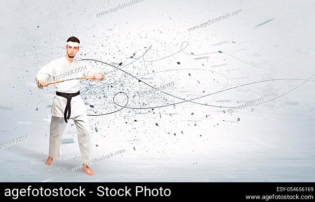 Young karate trainer doing karate tricks with chaotic concept