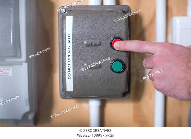 Hand turning off electrical control box