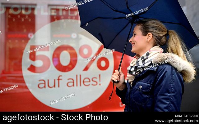 Woman with an umbrella, shopping, SALE, discount battle, price reductions, Corona crisis, Stuttgart, Baden-Württemberg, Germany