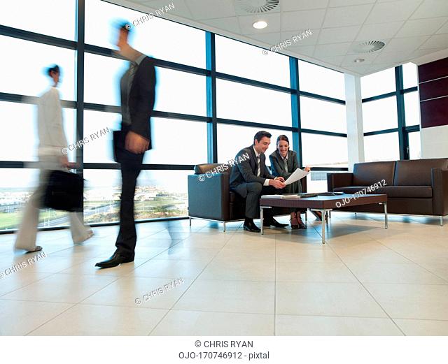 Business people working together in office waiting area