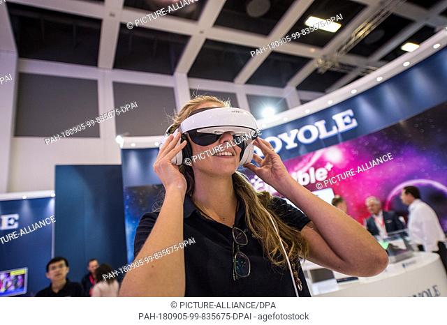 05 September 2018, Germany, Berlin: A woman tests a virtual reality cinema system from Royole on the last day of the trade fair for consumer electronics and...