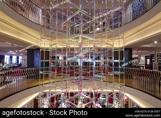 View across atrium with detail of suspended light sculpture. Iri-Descent , Fortnum & Mason, London, United Kingdom. Architect: Liz West, 2019