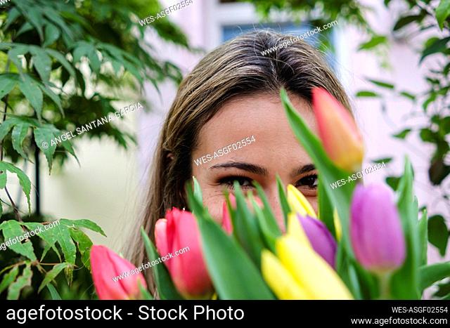 Young woman with fresh tulip flowers