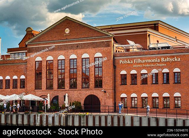 Brick-build building of Fryderyk Chopin Polish Baltic Philharmonic Hall in Gdansk by the river Old Motlawa