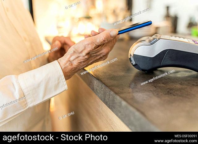 Senior woman making payment through smart phone