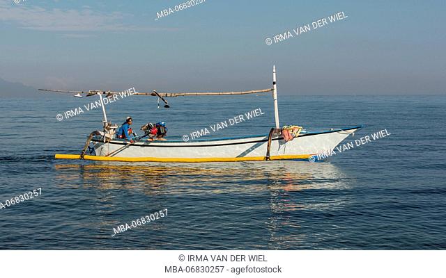 balinese fisherman in his Jukung (balinese outrigger canoe) early in the morning, Indian ocean
