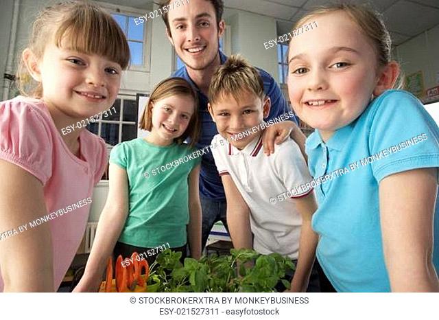 Teacher with children learning about plants